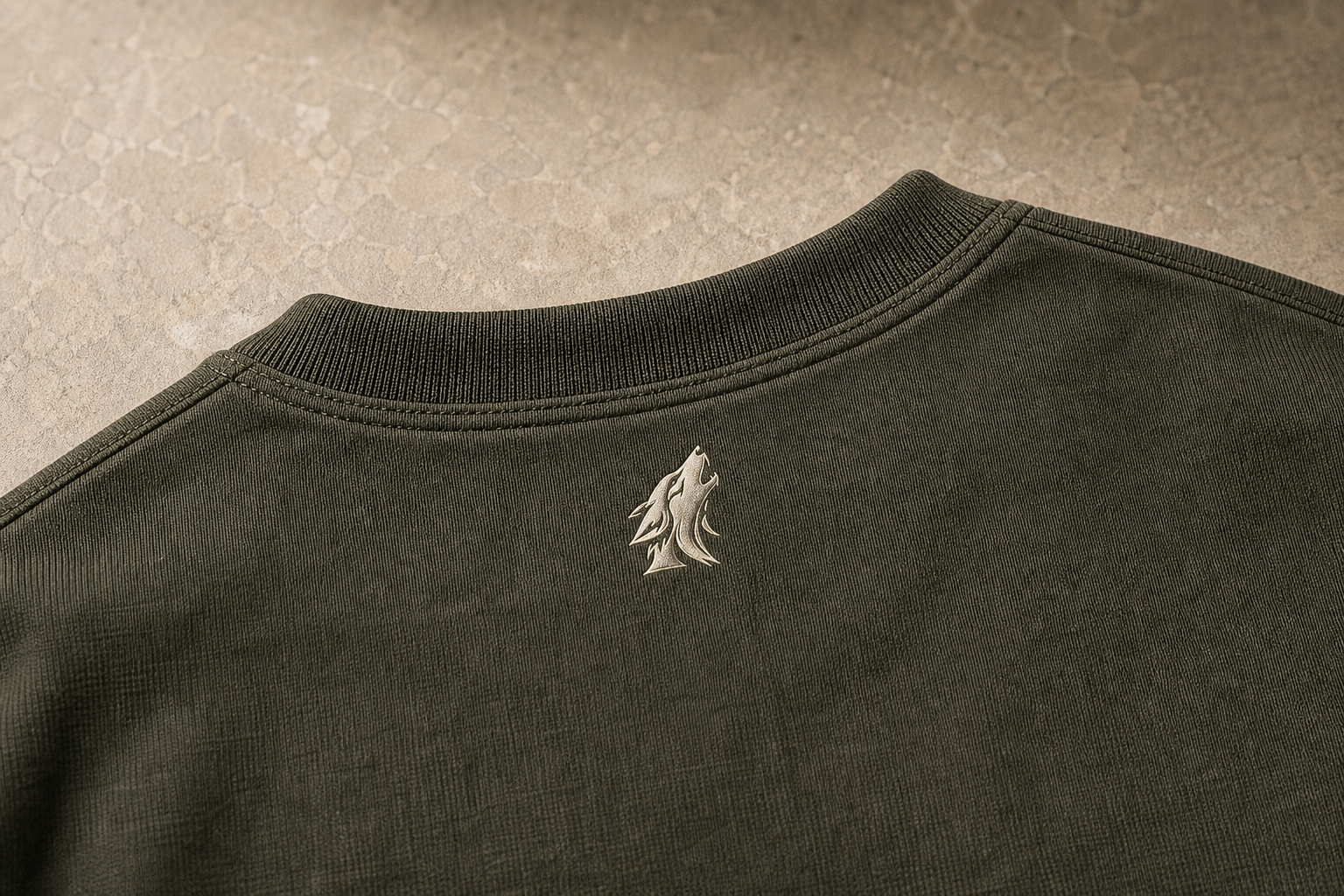 Close-up of the DYRWOLF Olive T-Shirt back collar mark