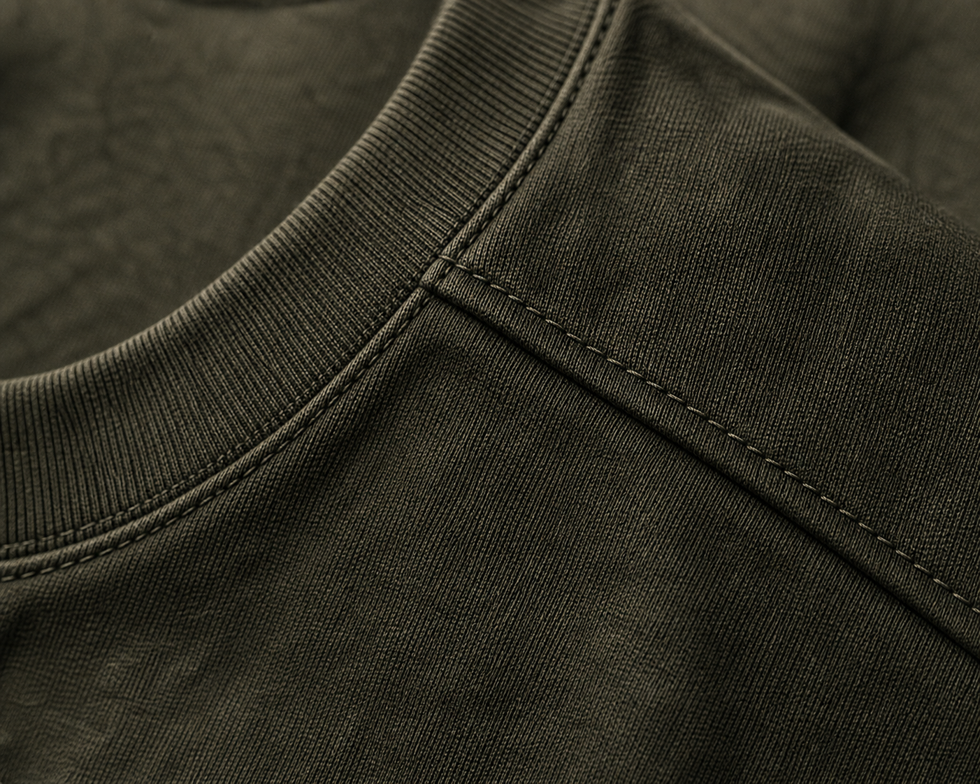 Macro detail of the DYRWOLF Olive T-Shirt fabric and stitching