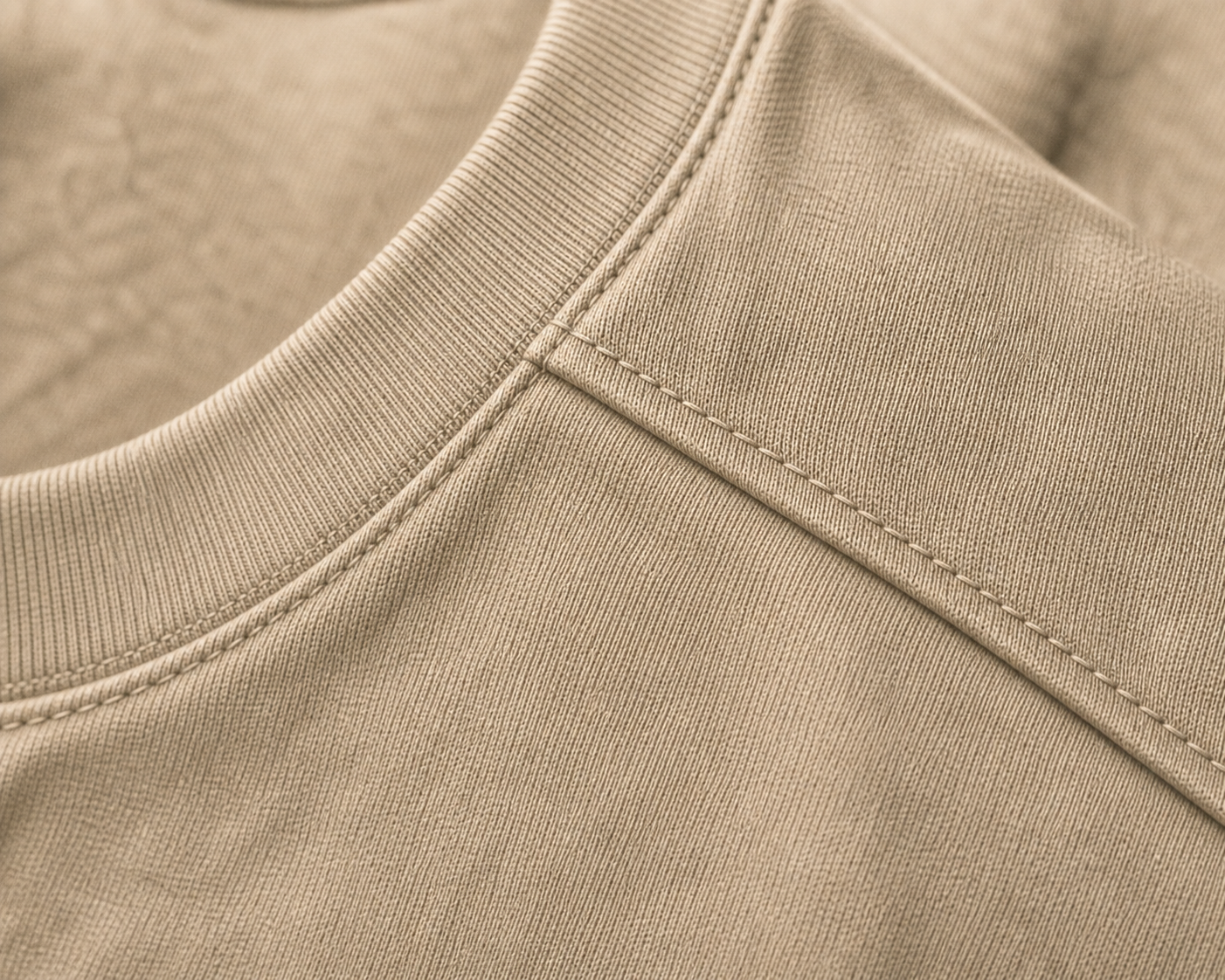 Macro detail of the DYRWOLF Sand T-Shirt fabric and stitching